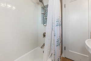 Full bathroom with shower / bath combination with curtain