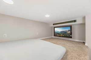 Unfurnished bedroom featuring carpet floors and baseboards