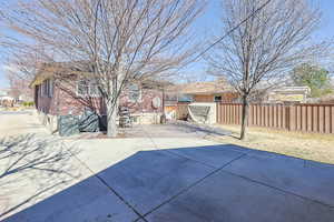 View of patio featuring fence