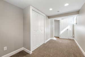 Unfurnished bedroom featuring carpet, baseboards, and recessed lighting