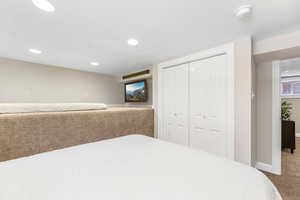 Bedroom with recessed lighting, a closet, carpet flooring, and baseboards