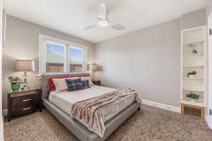 Bedroom featuring a ceiling fan, carpet, visible vents, and baseboards