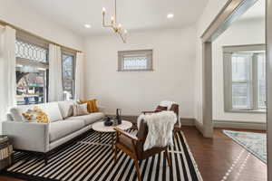 Living room with recessed lighting, refinished wood floors.