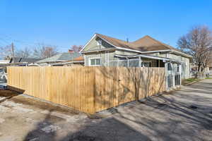 Southeast view house & fence on the alleyway