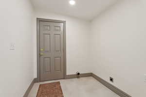 Laundry with door leading to the side porch and backyard.