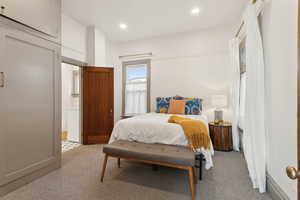 Master bedroom featuring light colored carpet and recessed lighting