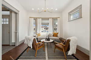 Living area with large stained glass window & refinished wood floors