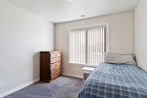 Bedroom featuring carpet, visible vents, and baseboards