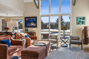 Living area featuring a towering ceiling and wood finished floors