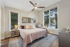 Bedroom featuring a ceiling fan, baseboards, and wood finished floors