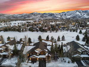 Snowy aerial view featuring a residential view and a mountain view