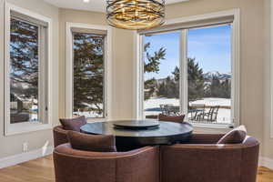 Dining room with a mountain view, baseboards, and wood finished floors