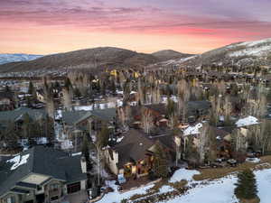 Snowy aerial view featuring a residential view and a mountain view