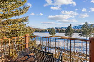 Balcony featuring a water and mountain view