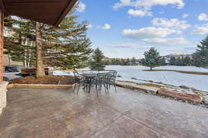 Snow covered patio featuring outdoor dining space