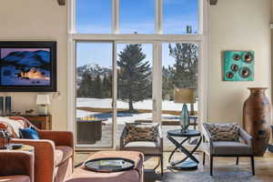 Living area with a mountain view and wood finished floors