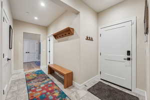 Mudroom with recessed lighting and baseboards