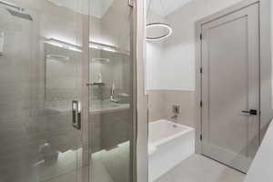 Bathroom featuring a stall shower, a garden tub, and tile patterned floors