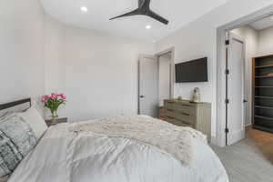 Carpeted bedroom featuring recessed lighting, ceiling fan, and baseboards