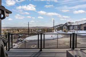 Snow covered deck with a mountain view