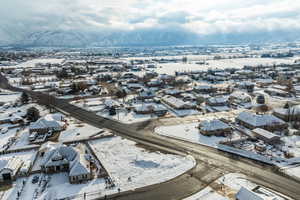 Snowy aerial view with a residential view and a mountain view