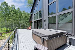 Wooden terrace featuring a hot tub