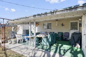 View of patio with a grill and a ceiling fan
