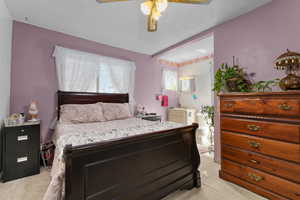 Bedroom featuring light carpet and ceiling fan