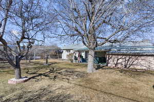 Exterior space featuring metal roof and a yard