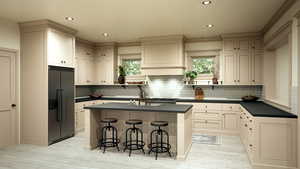 Kitchen featuring dark countertops, stainless steel built in refrigerator, a kitchen island, and a kitchen bar