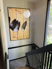 Stairs featuring baseboards and tile patterned floors