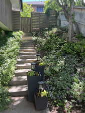 View of yard with stairs and fence