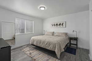 Bedroom featuring wood finished floors, visible vents, and baseboards