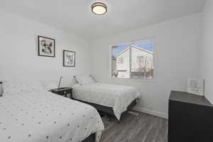 Bedroom with wood finished floors and baseboards