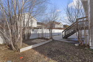 View of yard featuring stairway and fence