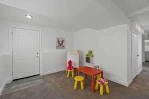 Game room featuring a textured ceiling, recessed lighting, carpet flooring, and baseboards