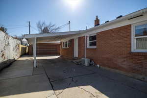 East side featuring driveway, a carport, garage and a fenced backyard