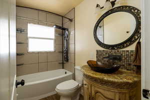 Waterfall Shower tub combo, Custom Vanity with a vessel sink.