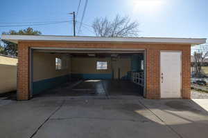 Detached garage with manual door.