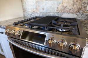 Details featuring touch screen range and gas stove