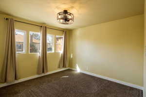 3rd bedroom carpeted with a remote controlled light/fan chandelier combo