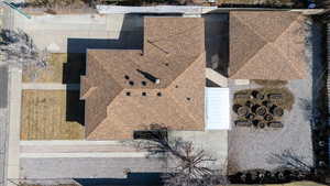 Drone / aerial view, the entire back yard is Xeroscaped and either concrete or gravel with the exceptions of the front lawn and the vegetable garden