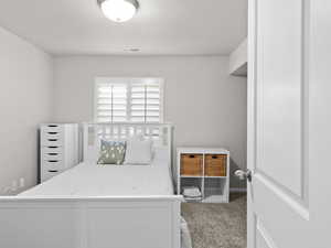 Carpeted bedroom featuring visible vents