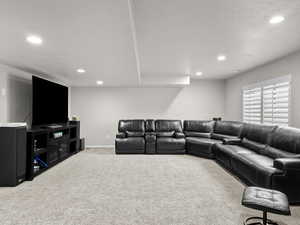 Living area with carpet, baseboards, and recessed lighting