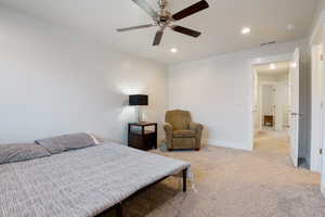 Bedroom with light carpet, baseboards, visible vents, ceiling fan, and recessed lighting