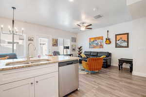 Kitchen with visible vents, dishwasher, light wood-type flooring, white cabinetry, and a sink