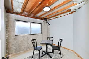 Dining room with concrete flooring and baseboards