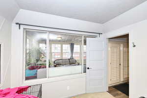 Interior space with a textured ceiling and wood finished floors