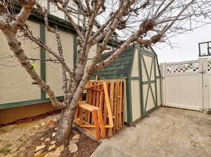 View of outdoor structure with an outdoor structure, fence, and a gate