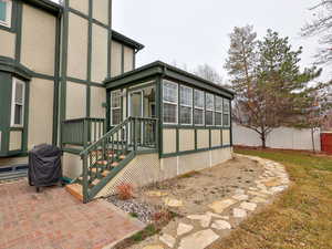 Exterior space featuring a patio area, fence, and stucco siding